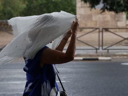 Una mujer se protege de la lluvia durante la tormenta caída el lunes en Valencia.