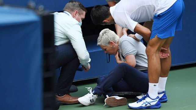 Sep 6, 2020; Flushing Meadows, New York, USA; Novak Djokovic of Serbia and a tournament official tend to a linesperson who was struck with a ball by Djokovic against Pablo Carreno Busta of Spain (not pictured) on day seven of the 2020 U.S. Open tennis tournament at USTA Billie Jean King National Tennis Center. Mandatory Credit: Danielle Parhizkaran-USA TODAY Sports     TPX IMAGES OF THE DAY