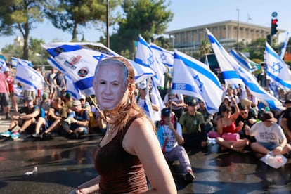The new law removes from the Supreme Court the power to overturn decisions of government, ministers or elected public officials that it deems unreasonable. This is one of the legal candidates endorsed by the court in a country where there is no constitution and where parliament elects the prime minister. Pictured, a protester wearing a mask representing Prime Minister Benjamin Netanyahu takes part in a sit-in to block the entrance to Parliament (the Knesset) in Jerusalem on Monday.