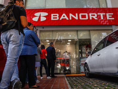 Clientes hacen fila para usar cajeros automáticos en una sucursal bancaria de Grupo Financiero Banorte, en Ciudad de México.