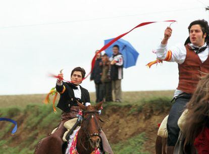 Dos jóvenes jinetes participan en la carrera de cintas a caballo del carnaval de Torrelobatón, en Valladolid.