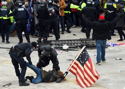 Police detain a protester at the pro-Donald Trump protest in front of the Capitol on January 6, 2021.
