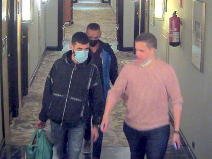 La víctima, a la derecha de la imagen, entrando con los dos acusados de matarle en el hotel.