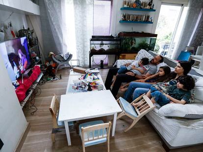 Una familia mira la televisión en casa durante el confinamiento, en Madrid.
