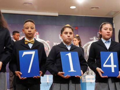 Los niños de San Ildefonso muestran el 37.142, agraciado con el primer premio del sorteo de la lotería de El Niño.