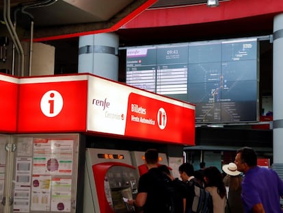 Unos viajeros sacan los billetes de tren en la estación de Atocha Cercanías.