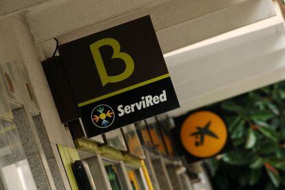 FILE PHOTO: Bankia and Caixabank's logotypes are seen during the coronavirus disease (COVID-19) outbreak near Barcelona, Spain September 18, 2020. REUTERS/Albert Gea/File Photo
