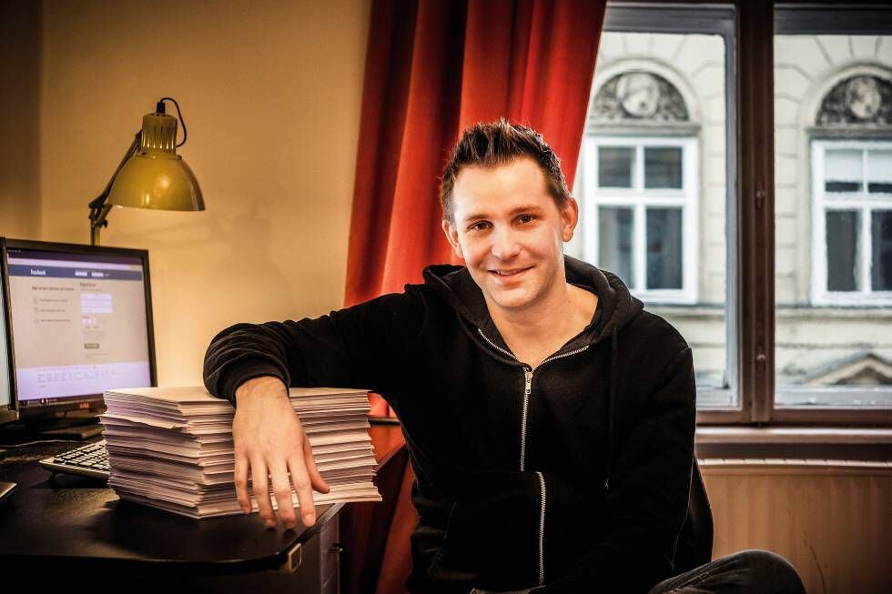 Max Schrems, en su apartamento de Viena, apoyado sobre las 1.200 hojas de información personal que Facebook recopiló sobre él.