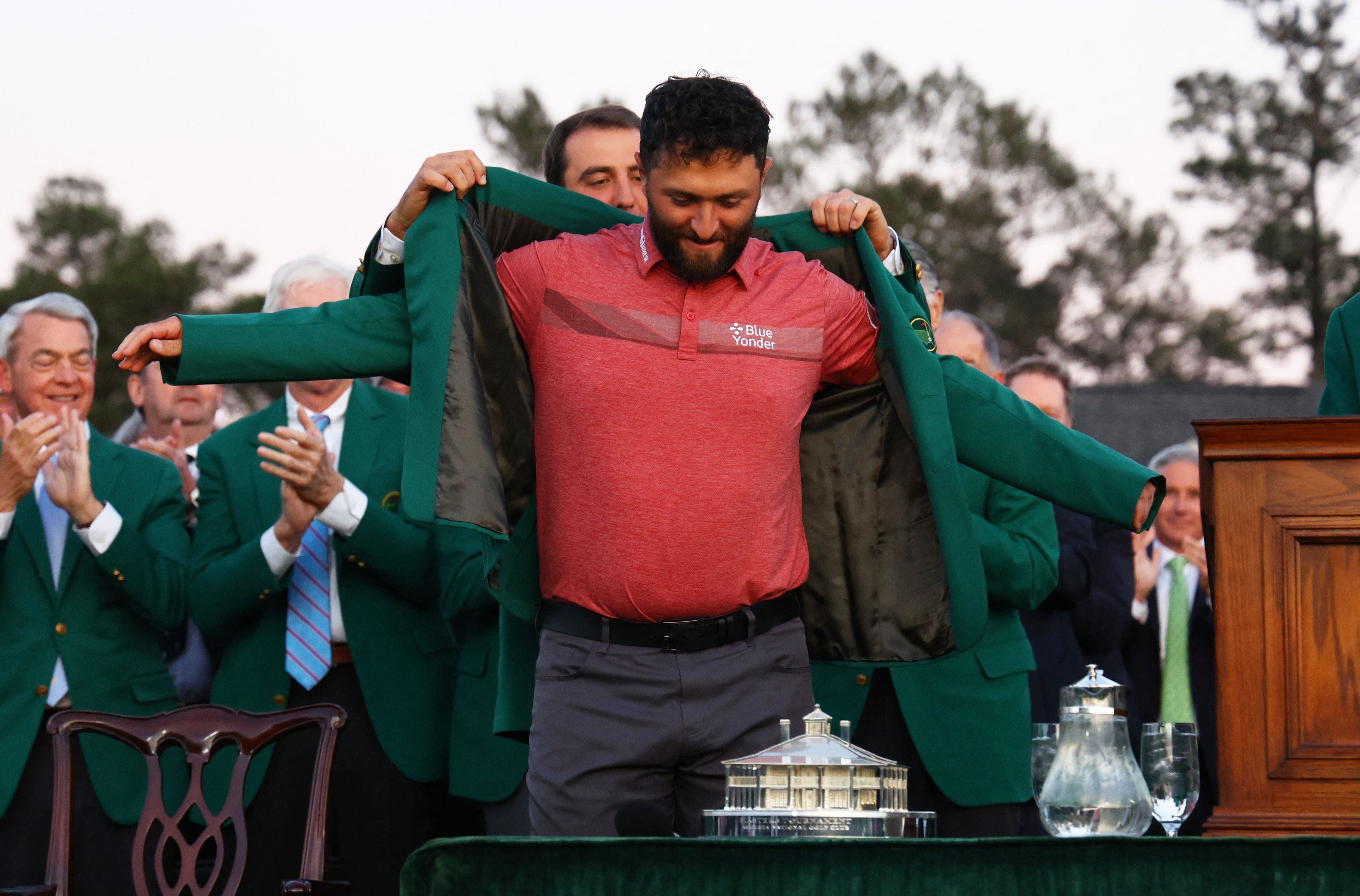 Golf - The Masters - Augusta National Golf Club - Augusta, Georgia, U.S. - April 9, 2023 Spain's Jon Rahm is presented with the green jacket by Scottie Scheffler of the U.S. after winning The Masters REUTERS/Mike Segar
