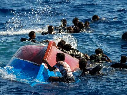 Un grupo de migrantes nadan tras el volcado de su embarcación, al sur de la isla italiana de Lampedusa en el mar Mediterráneo, el 11 de agosto de este año.