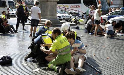 Policías y un médico atienden a víctimas del atentado en Barcelona.
