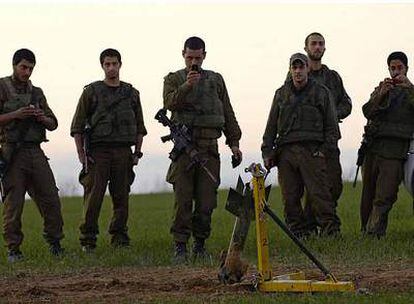 Soldados israelíes observan los restos de un cohete lanzado ayer desde la franja de Gaza y que aterrizó cerca de un <i>kibutz.</i>
