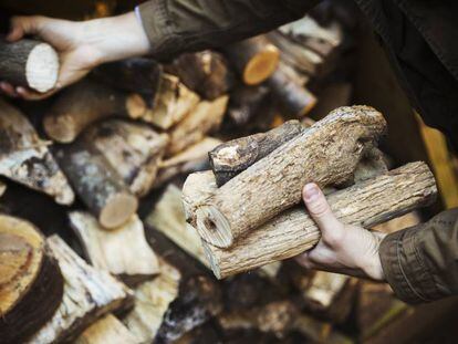 Un hombre apilando trozos de madera.