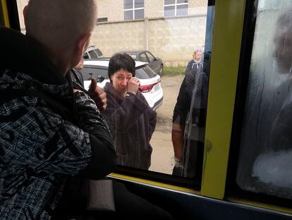 A Russian recruit, back to a camera, looks through a bus window at his mother at a military recruitment center in Volgograd, Russia, Saturday, Sept. 24, 2022. Russian President Vladimir Putin on Wednesday ordered a partial mobilization of reservists to beef up his forces in Ukraine. (AP Photo)