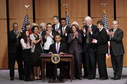 El presidente de Estados Unidos, Barack Obama, (en el centro) firma la ley que reforma los préstamos universitarios en presencia, entre otros, de la presidenta de la Cámara de Representantes, Nacy Pelosi.