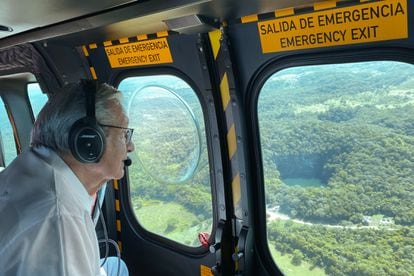 López Obrador observes the area through which the Mayan train will run, in Campeche.
