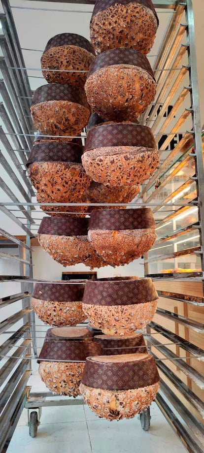 The panettone should rest face down once made, like these in the PanDomè workshops. 