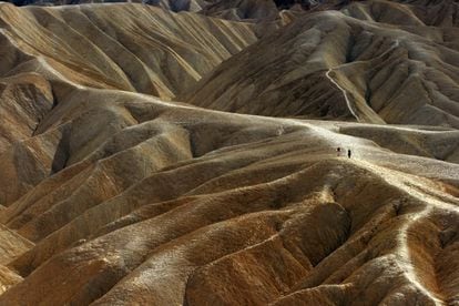 Dos personas caminan por Zabriski Point, en Death Valley (California).