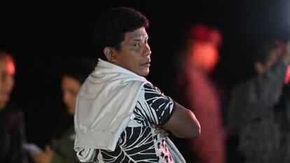 Manuel Ranoque, father of the four Indigenous children who were found alive after being lost for 40 days in the Colombian Amazon forest following a plane crash, stands on the tarmac as his children are being taken into ambulances upon landing at the CATAM military base in Bogota on June 10, 2023. Four Indigenous children who had been missing for more than a month in the Colombian Amazon rainforest after a small plane crash have been found alive, President Gustavo Petro said on June 9, 2023. (Photo by Juan BARRETO / AFP)