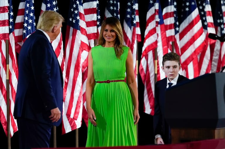 President Donald Trump appears on stage with first lady Melania Trump after he gave a speech from the South Lawn of the White House on the fourth day of the Republican National Convention, Thursday, Aug. 27, 2020, in Washington. Barron Trump is at right. (AP Photo/Alex Brandon)