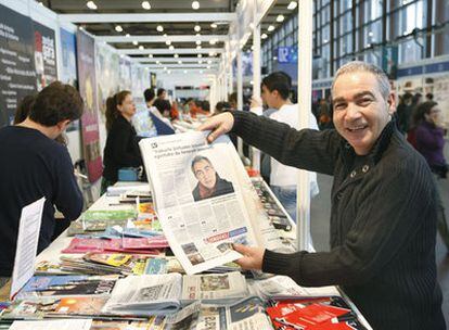 El escritor catalán Andreu Carranza, encargado de inaugurar la feria, muestra su imagen impresa en un periódico local