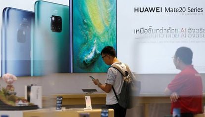 Un cliente revisa un teléfono Huawei en una tienda de la marca en Bangkok.