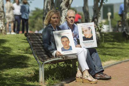Rosa e Isidro muestran las fotos de su hijo Paco Molina, desaparecido en 2015 en el parque de Córdoba donde posan.