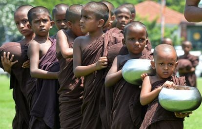 Un grupo de monjes budistas hace cola para recibir ofrendas de comida en Colombo, Sri Lanka.