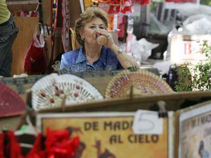 Una mujer bebe un refresco en un negocio turístico.