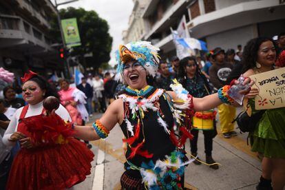 Personas participan en una marcha para conmemorar el Día de la Revolución de 1944, este viernes en Ciudad de Guatemala.