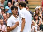 Russia's Daniil Medvedev (R) shakes hands with Spain's Carlos Alcaraz after winning their men's singles second round match on the fourth day of the 2021 Wimbledon Championships at The All England Tennis Club in Wimbledon, southwest London, on July 1, 2021. (Photo by Ben STANSALL / AFP) / RESTRICTED TO EDITORIAL USE