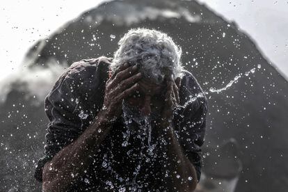 Un hombre se lava el rostro durante un descanso en la fábrica de carbón vegetal de Al-Hattab en la Franja de Gaza.
