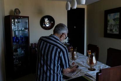 Martin Mestre searches the photographs of his daughter Nancy Mariana. 