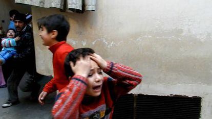 Un hombre lleva a un niño en brazos en Homs en una imagen sin fecha.