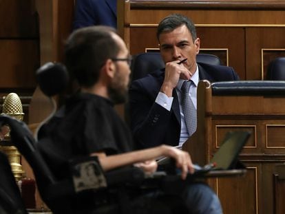 El presidente del Gobierno, Pedro Sánchez, escucha al portavoz parlamentario de Unidas Podemos, Pablo Echenique, en una sesión del Congreso.