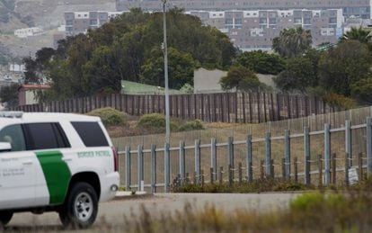Un coche de la policía fronteriza junto a la valla entre California y México