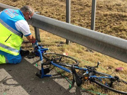 Un m&eacute;dico, junto a la bicicleta del fallecido, en el lugar del accidente. 