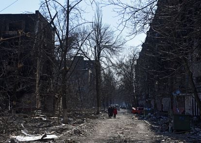 People were walking through the devastated streets of Mariupol on Friday.