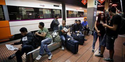Viajeros esperan en la estaci&oacute;n de Barcelona-Sants, este lunes.