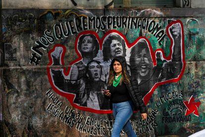 Una joven pasa frente a una pintada referida al XXXIV Encuentro Nacional de Mujeres, celebrado en Argentina en octubre. 