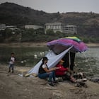 A family has lunch under a tent on the banks of the Madin Dam. Currently, Mexico City has a demand of 480 billion liters of water per year.
