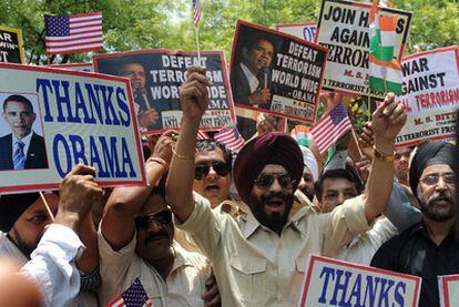 Activistas del Frente Antiterrorista sostienen carteles a favor del presidente de EE UU, Barack Obama, durante una manifestación en Nueva Delhi.