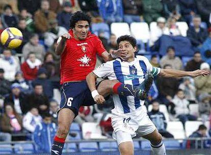 Nekounam y Jesús Vázquez saltan a por un balón.