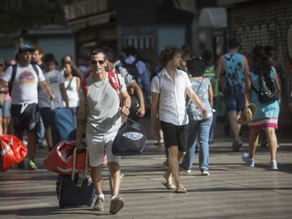 Turistas con maletas en La Rambla de Barcelona.