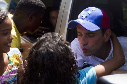 El candidato presidencial Henrique Capriles saluda a una de sus simpatizantes despu&eacute;s de un mitin en Cupira (Venezuela).