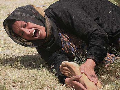 Una mujer llora junto al cadáver de su padre, tiroteado ayer en el distrito Ameriya de Bagdad.