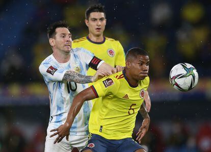 Lionel Messi and Wilmar Barrios compete for the ball in a match between Argentina and Colombia