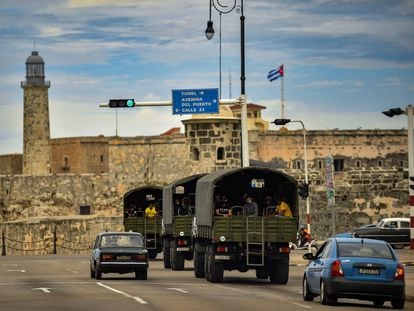 Police vehicles drive along El Paseo del Prado street in Havana, on November 15, 2021. - The Cuban opposition has said it will take to the streets as planned on Monday to demand the release of political prisoners, despite authorities banning the demonstration and preventing its organizers leaving their homes the day before. News of the "15N" (November 15) gathering in Havana and six provinces has spread rapidly on Cuban social media platforms in past weeks, with opposition supporters planning to highlight the continued detention of hundreds of prisoners jailed since history-making protests in July. (Photo by YAMIL LAGE / AFP)