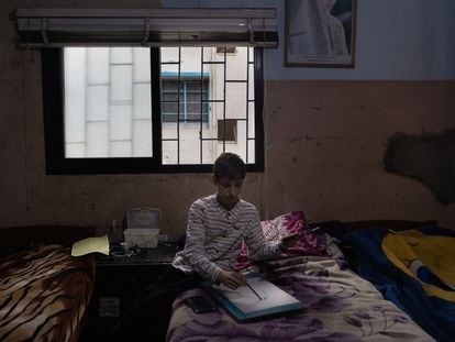 Rahif Almeari, a 13-year-old Palestinian artist, draws in his room. On the walls, the marks of bullet holes from the last outbreak of violence in Ein el-Hilweh, the largest Palestinian refugee camp in Lebanon.