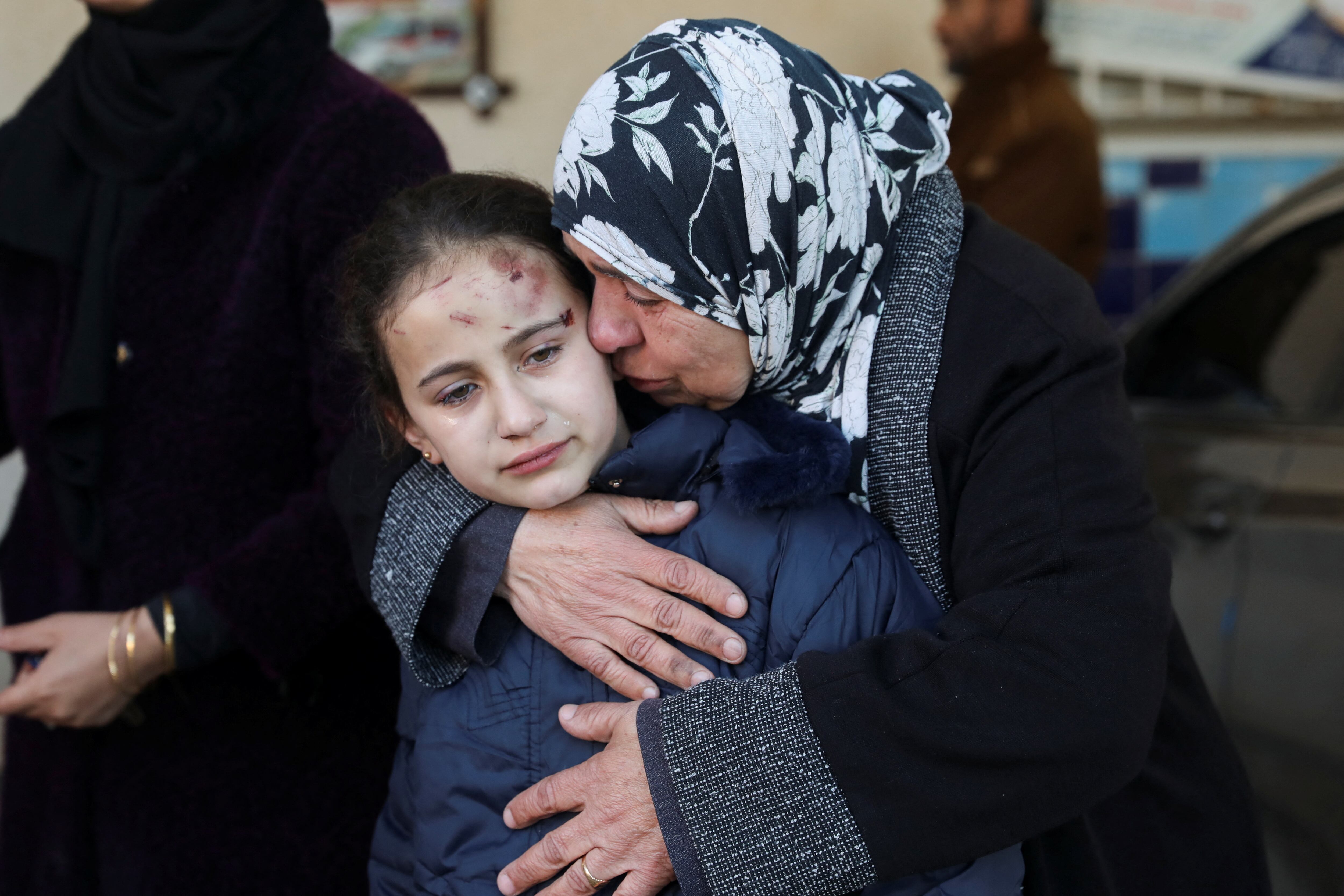Palestinian girl Rofan Nasser, who was wounded in an Israeli strike in which her parents and three of her siblings were killed, is comforted by her grandmother at the European hospital, in Khan Younis in the southern Gaza Strip, January 6, 2024. REUTERS/Arafat Barbakh